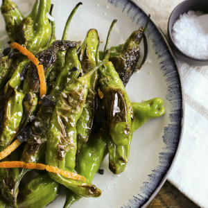 Pan-fried shishito peppers make a quick, economical and an addictively delicious happy hour snack.