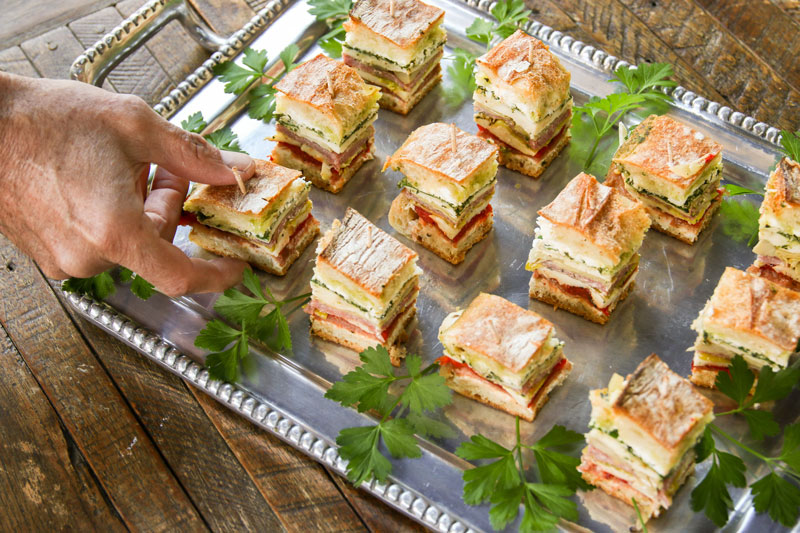Pressed brick sandwiches will become your latest addiction. Thinly sliced ingredients are packed between cheese-covered ciabatta bread and pressed together.