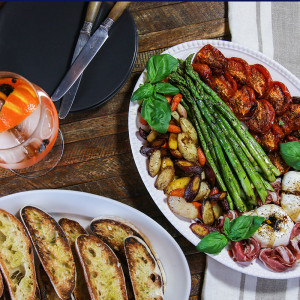 This vegetable-dense crostini platter does dual duty as an appetizer platter or a complete meal. A luscious ball of burrata & salty prosciutto round it out.